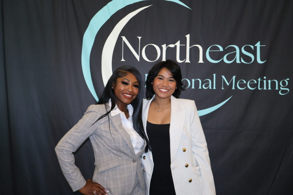 Two business development representatives smiling