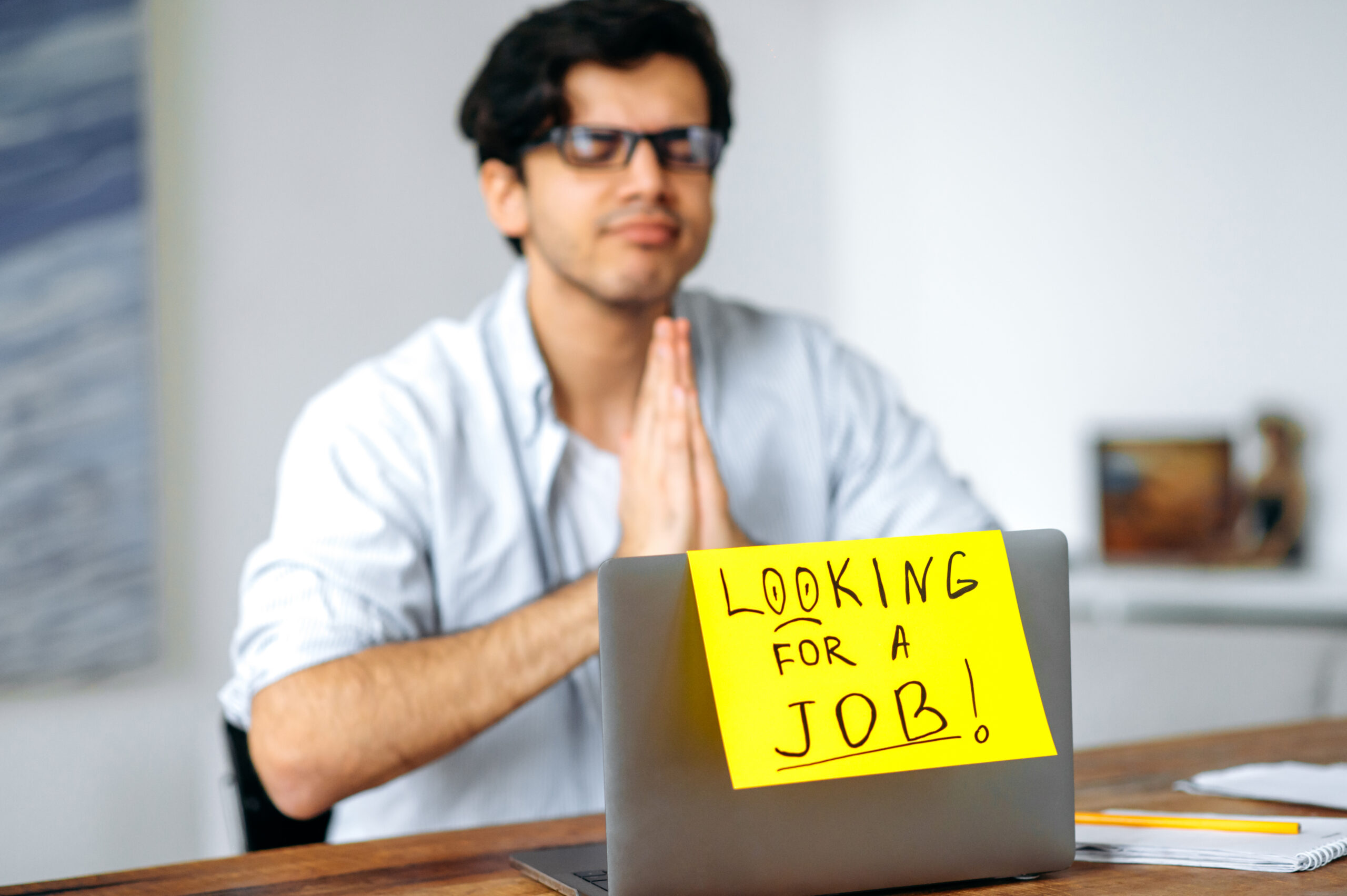 A student praying for sales and marketing jobs on their laptop