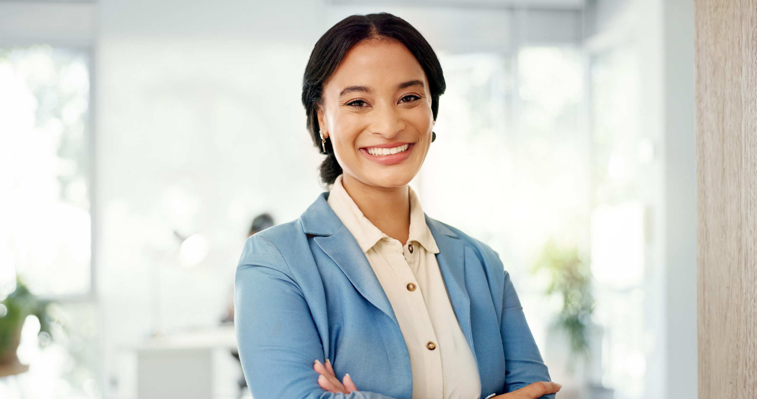 A marketing summer intern crossing their arms